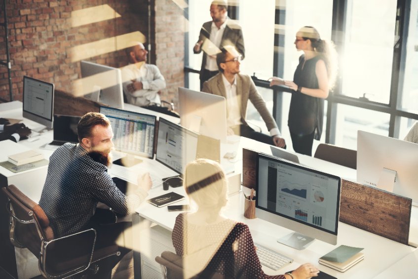 Bureau moderne, équipe travaillant sur ordinateurs.