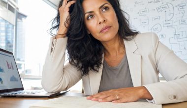 Professionnelle réfléchissant à son bureau avec ordinateur